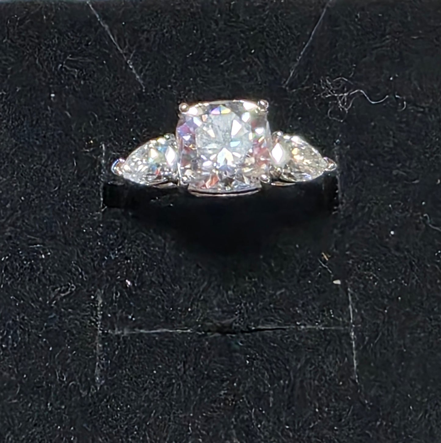 1111 3ctw Cushion Cut Center stone with approx (2) .30ct Pear cust stones on each side for total 3.78ctw Set in .925ss Sz 5